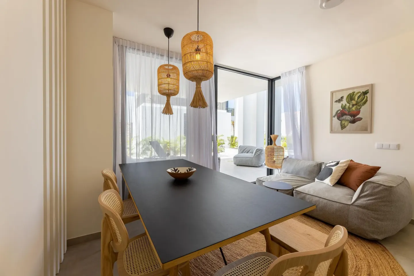 Premium Villa dining and living area with woven pendant lights at Coral Estate Luxury Resort.