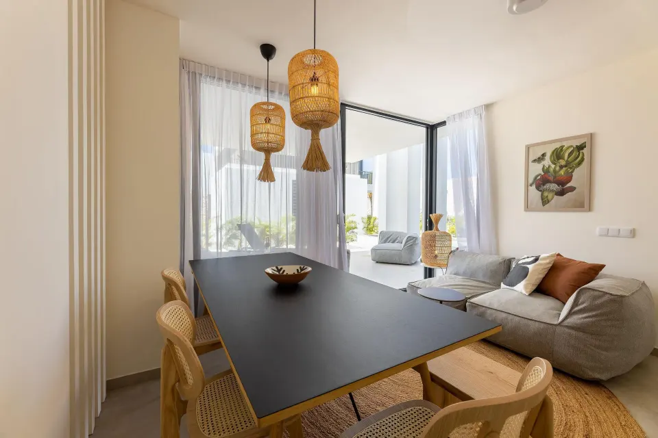 Premium Villa dining and living area with woven pendant lights at Coral Estate Luxury Resort.