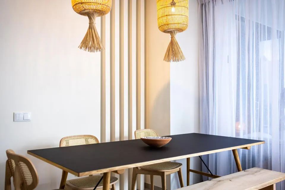 Premium Villa dining table with cane chairs and pendant lights at Coral Estate Luxury Resort.