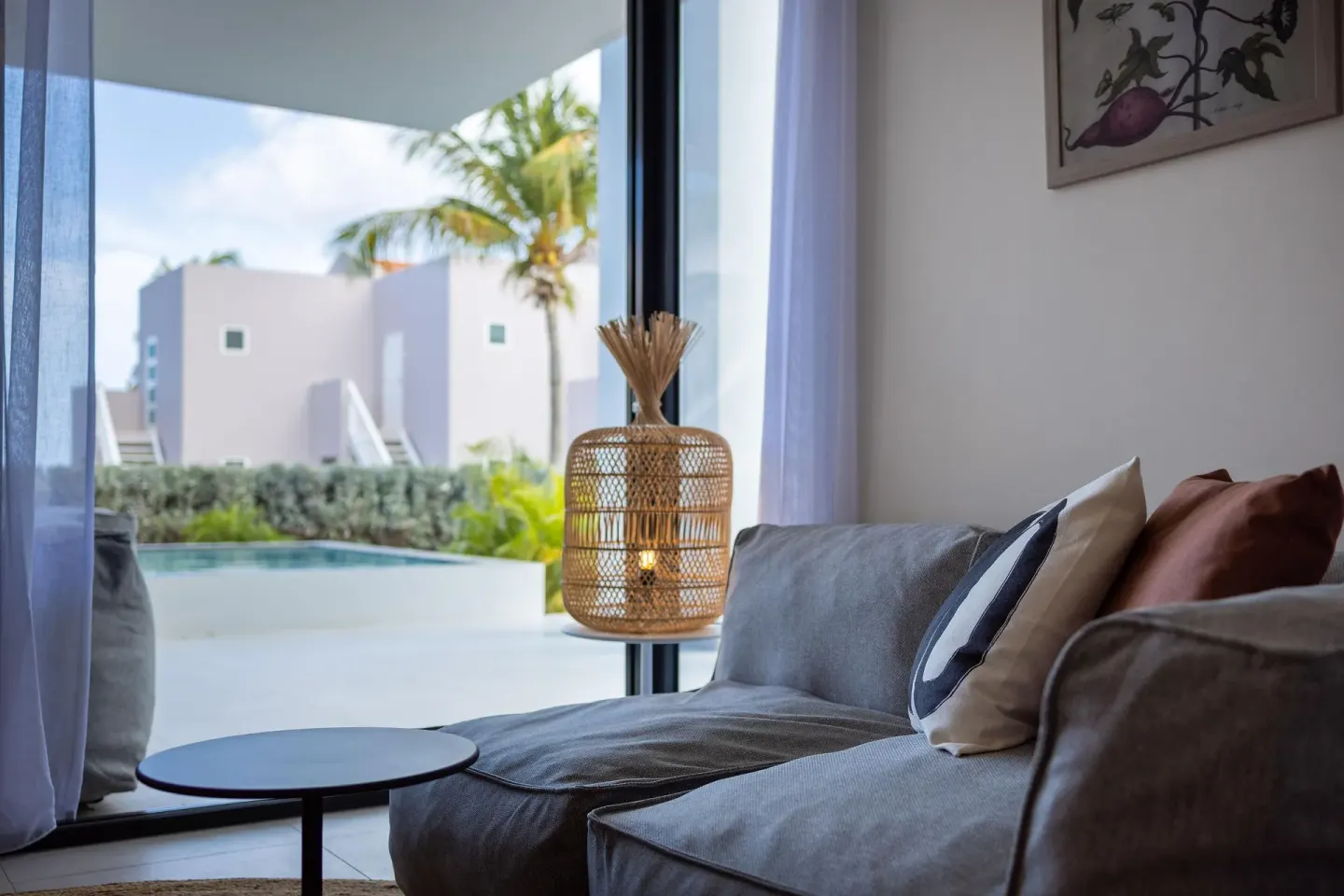 Premium Villa living area with gray sofa and pool view at Coral Estate Luxury Resort.