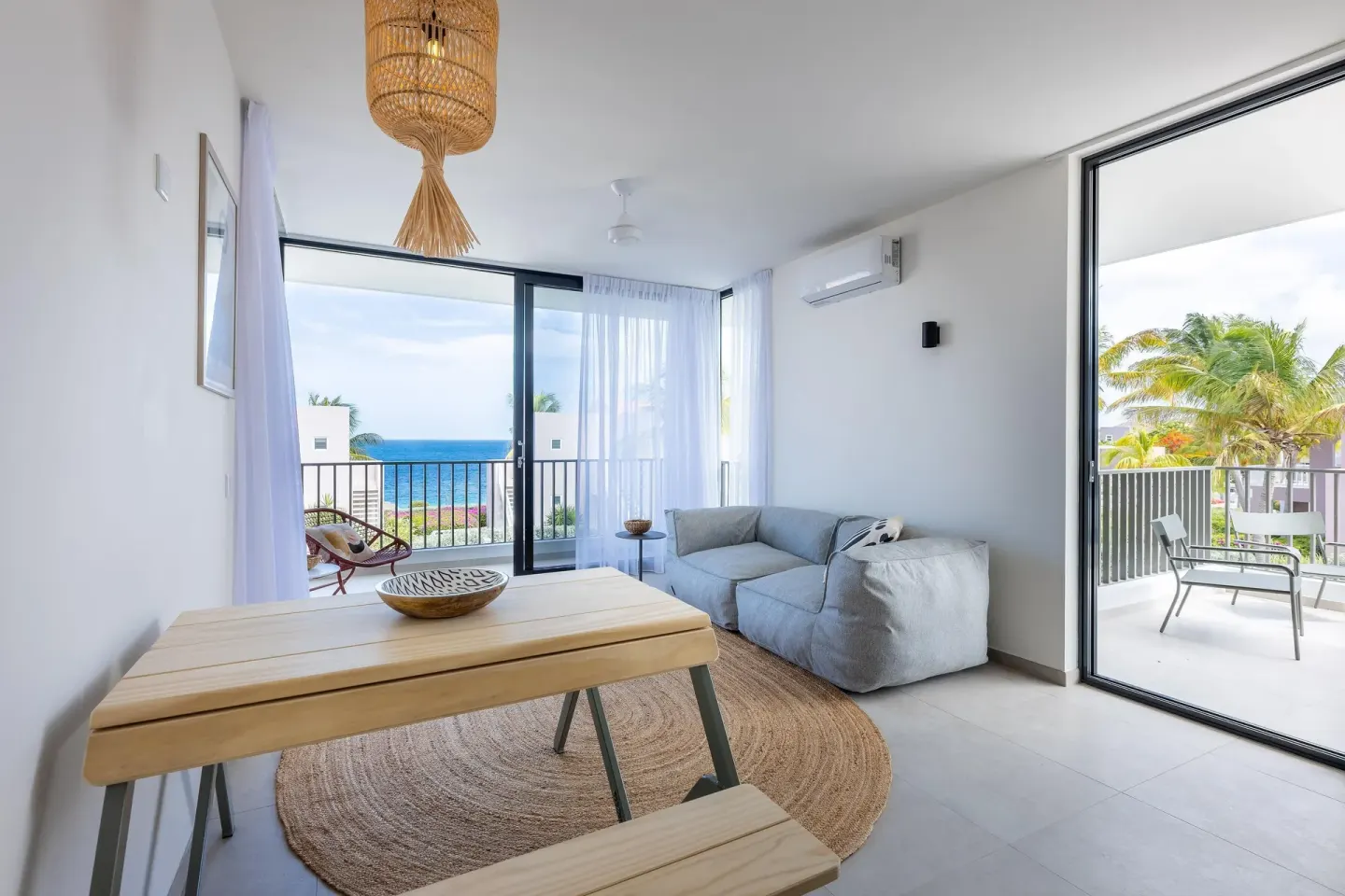 Premium Villa living and dining space with ocean-facing balcony at Coral Estate Luxury Resort.