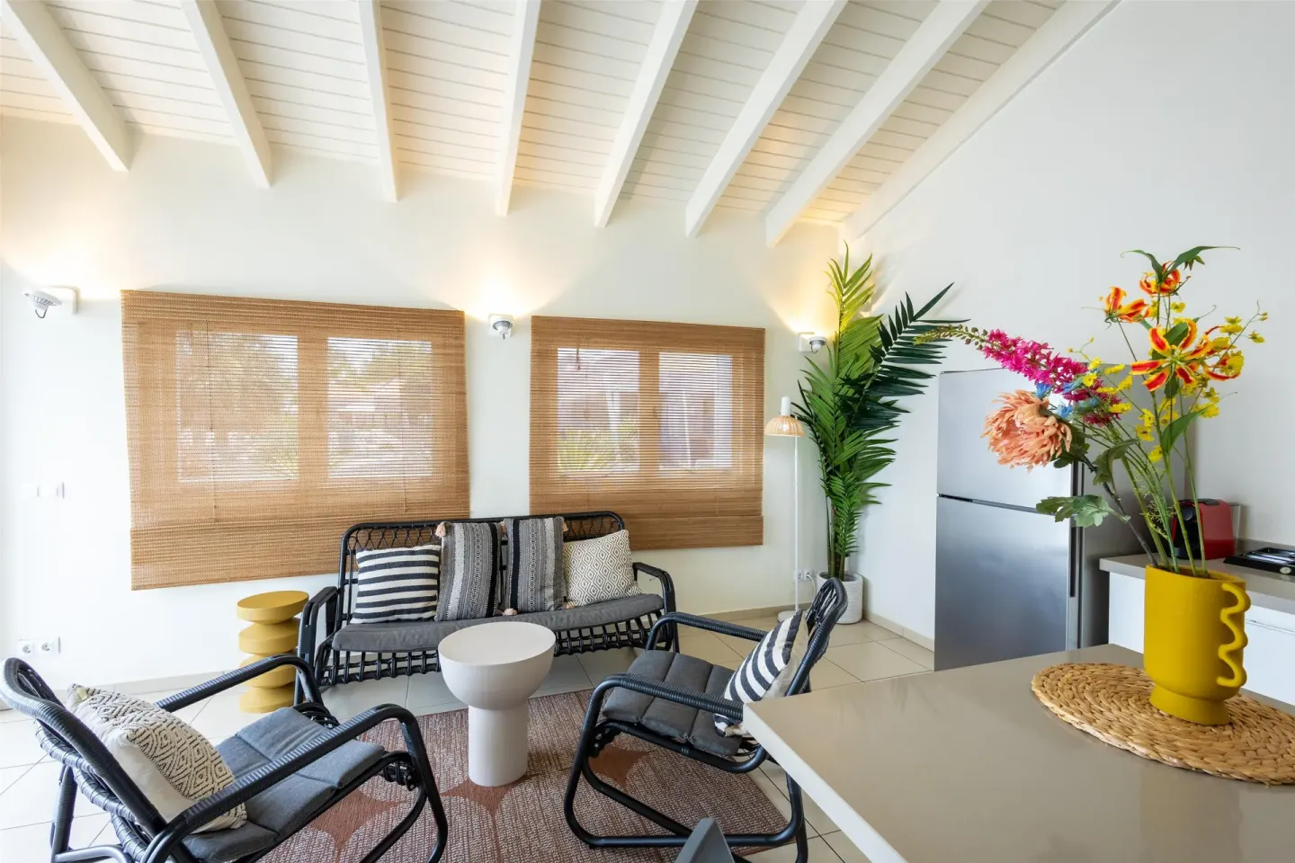 Apartment sitting area with woven shades at Coral Estate Luxury Resort.