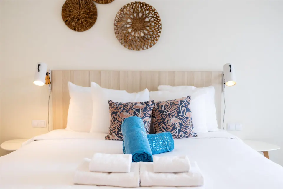 Superior Apartment bedroom with white bed and towels at Coral Estate Luxury Resort.