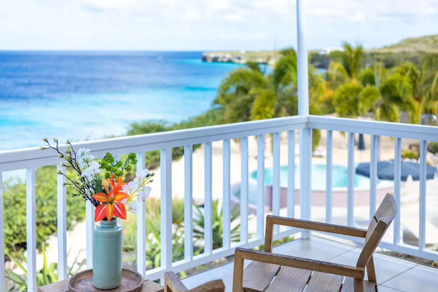 Superior Oceanfront balcony with chairs and sea view at Coral Estate Luxury Resort.