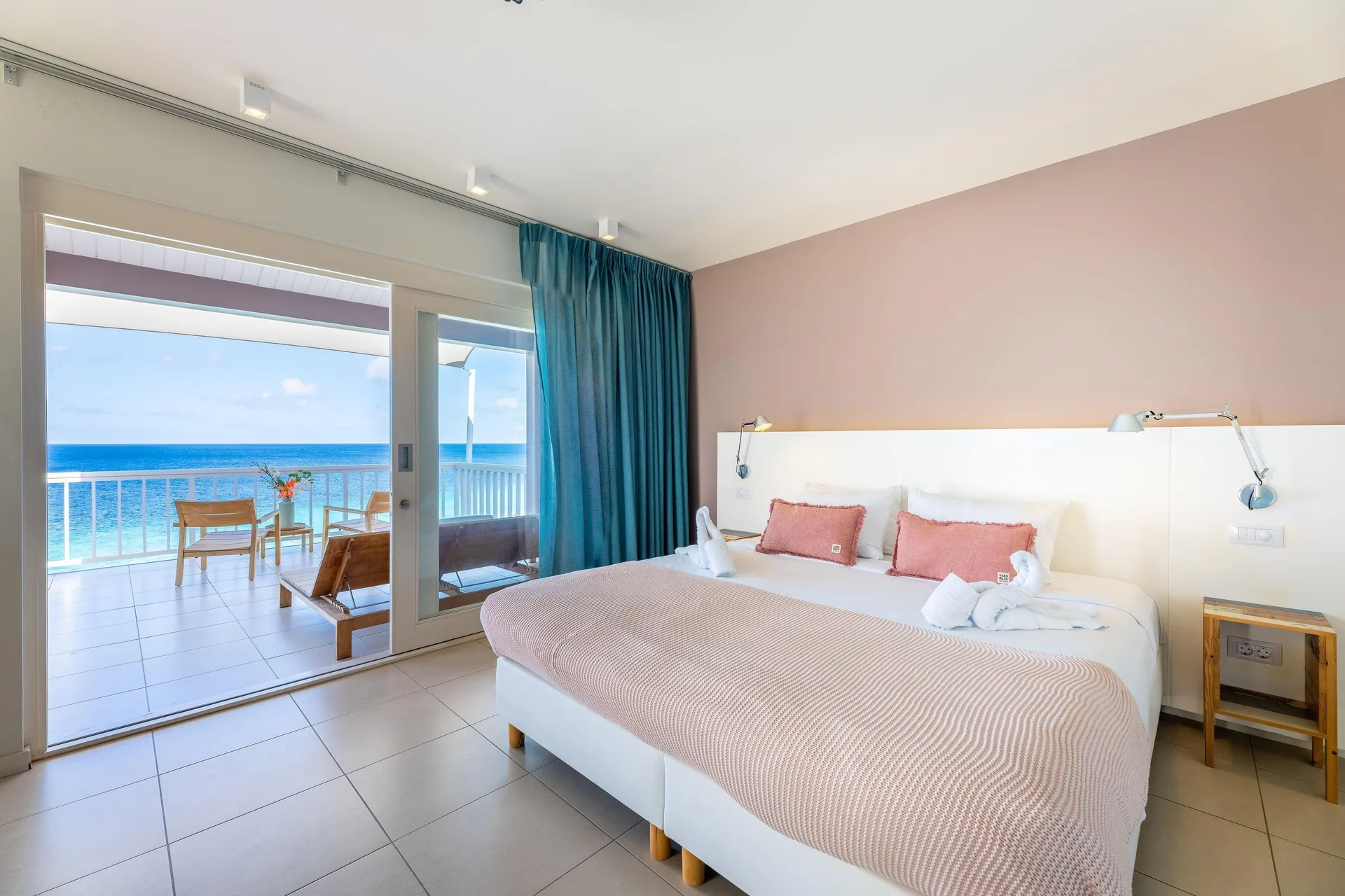 Superior Suite Ocean View Vip at Coral Estate Luxury Resort with twin beds, modern Caribbean design, and oceanfront balcony views in Curaçao.