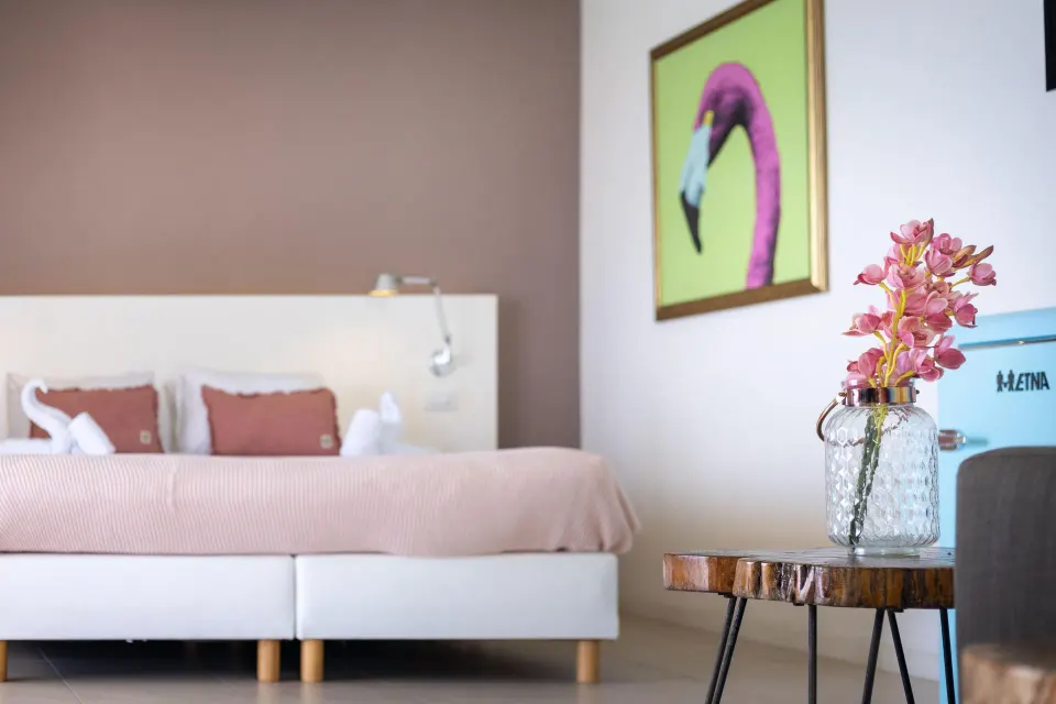Superior Oceanfront room detail with bed and flowers at Coral Estate Luxury Resort.