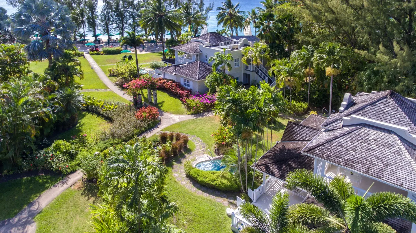 Aerial view of garden paths, palms, and resort buildings at Coral Reef Club.