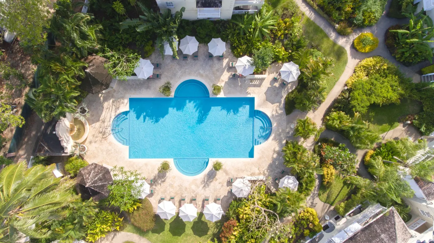 Aerial view of the main pool surrounded by gardens at Coral Reef Club.