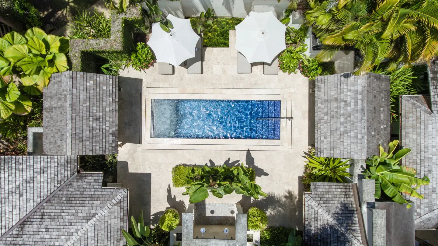 Aerial view of a narrow private pool between villas at Coral Reef Club.