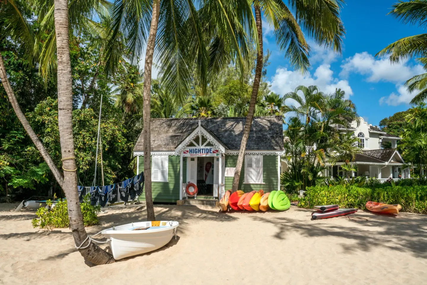 Beach watersports hut with kayaks and sailboats at Coral Reef Club.