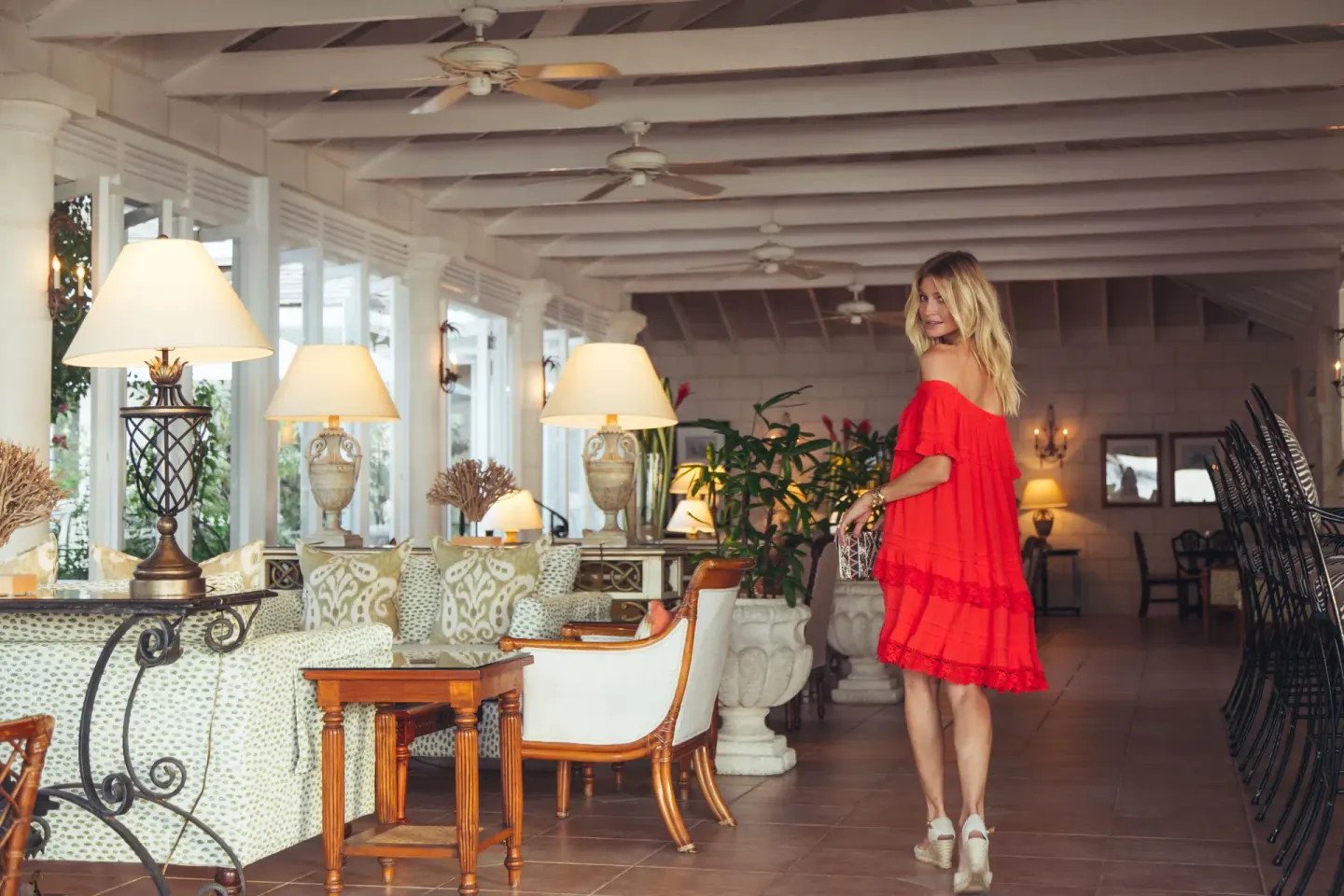 A guest walks through a furnished lounge at Coral Reef Club.