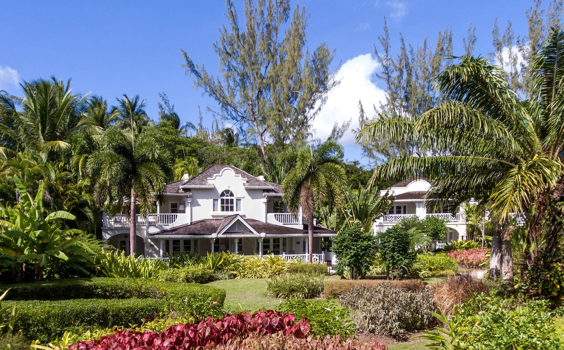 White resort buildings set in tropical gardens at Coral Reef Club.