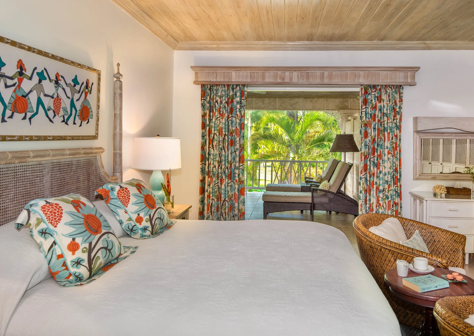 Cottage guest room with king bed and balcony seating at Coral Reef Club.