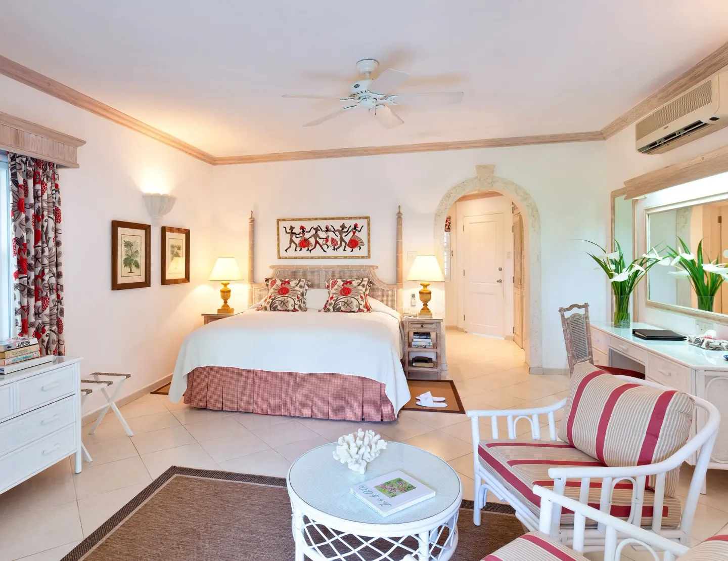 Cottage guest room with king bed and sitting area at Coral Reef Club.
