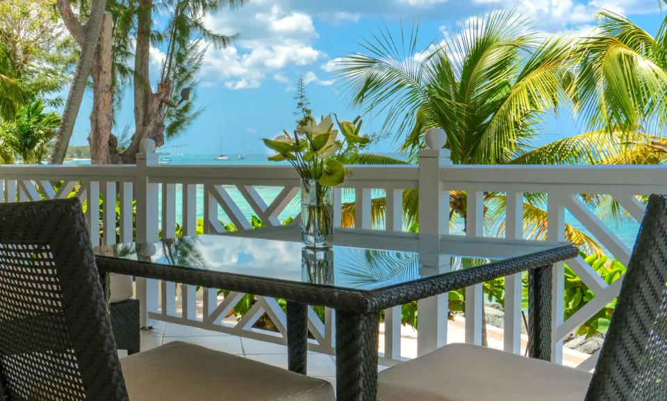 Junior Suite balcony dining table with sea view at Coral Reef Club.