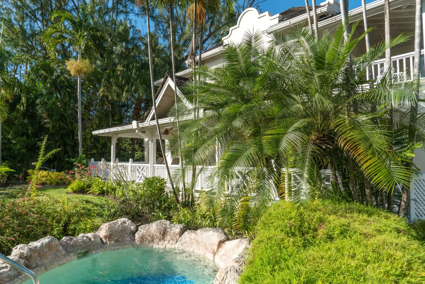 Luxury Cottage exterior with lush gardens and small plunge pool at Coral Reef Club.