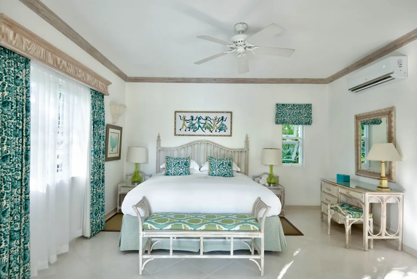 Luxury Cottage bedroom with a white bed and teal accents at Coral Reef Club.