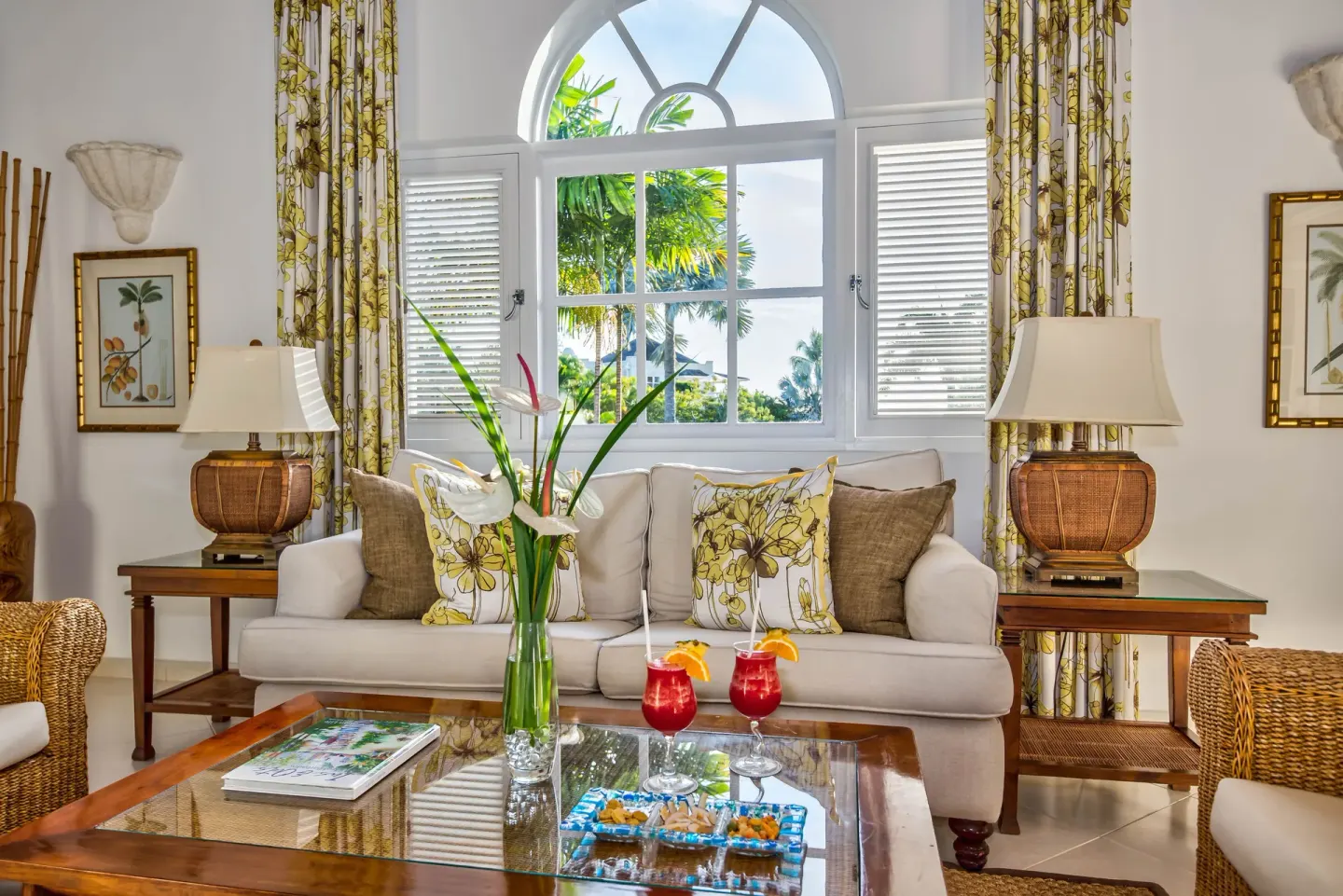 Luxury Cottage living room sofa beneath an arched window at Coral Reef Club.