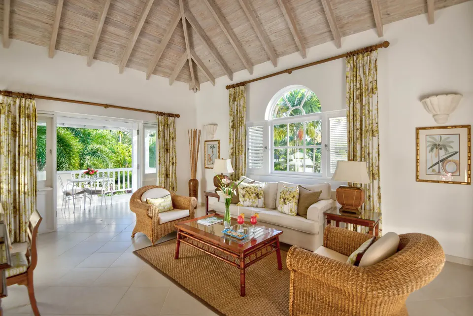 Luxury Cottage living room with vaulted ceiling and terrace doors at Coral Reef Club.