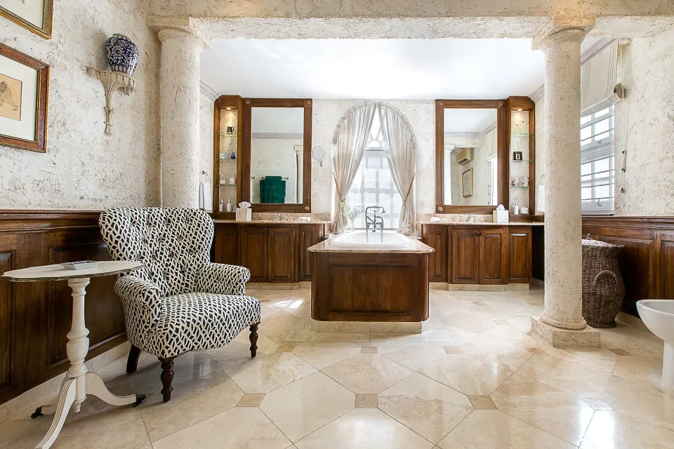 Luxury Suite bathroom with freestanding tub and double vanity at Coral Reef Club.