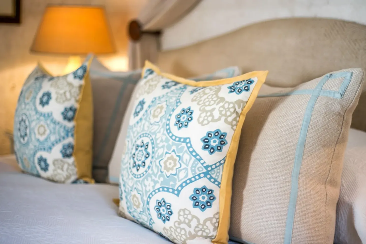 Patterned pillows on a Luxury Suite bed at Coral Reef Club.