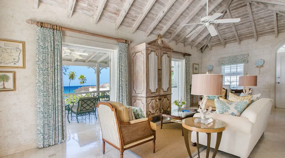 Luxury Suite living room with balcony and sea view at Coral Reef Club.