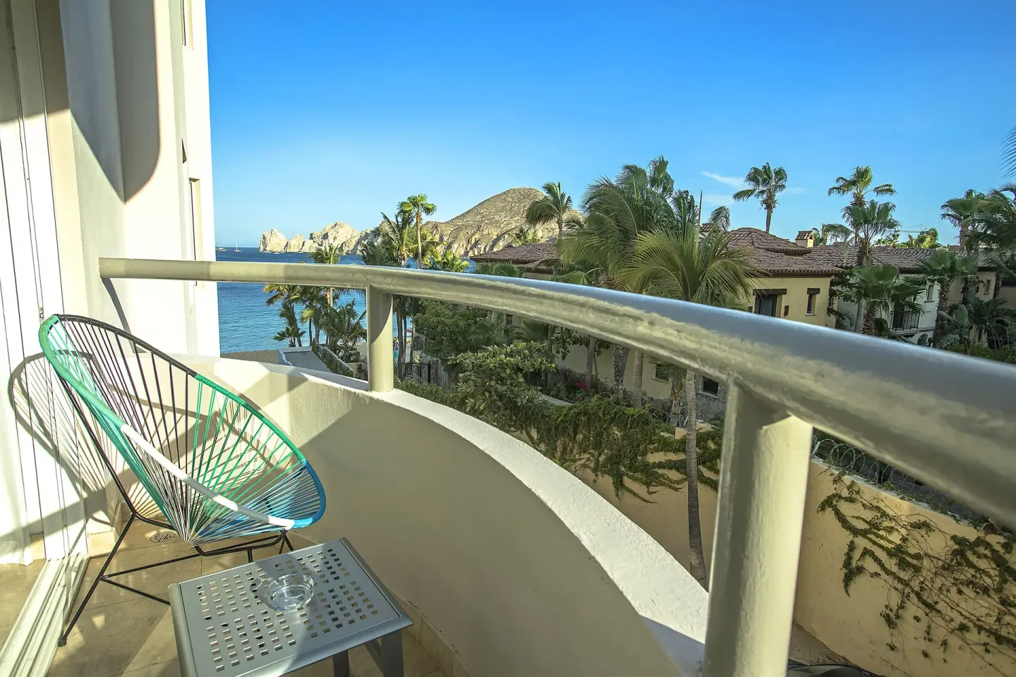 Curved balcony with chair and ocean view at Corazón Cabo.
