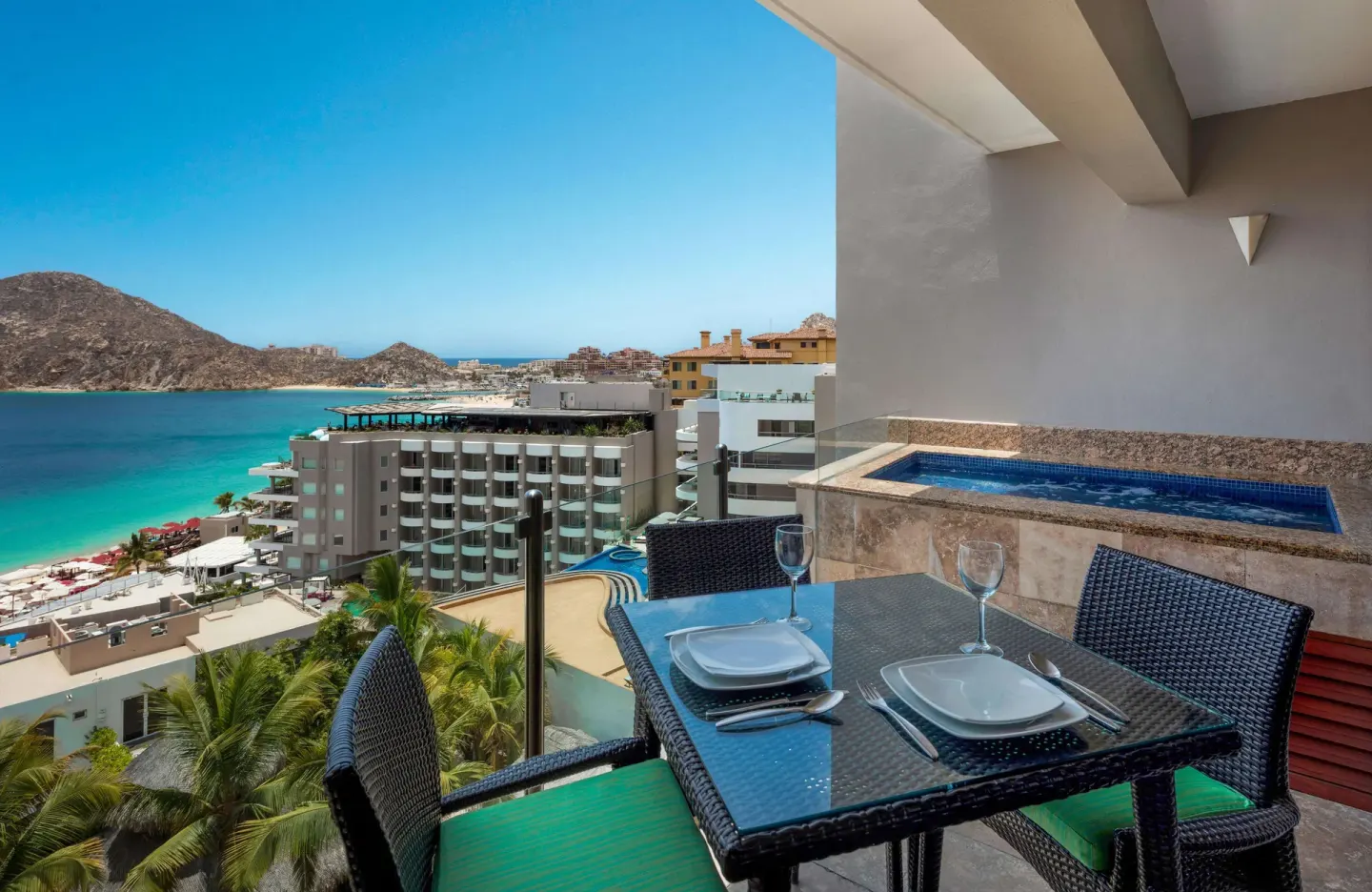 Private balcony with dining table, plunge pool, and bay view at Corazón Cabo.