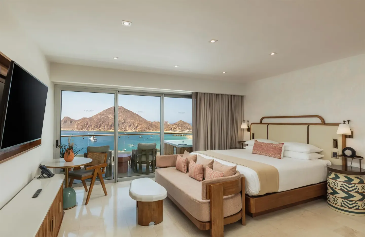 King-bed guest room with ocean view and balcony at Corazón Cabo.