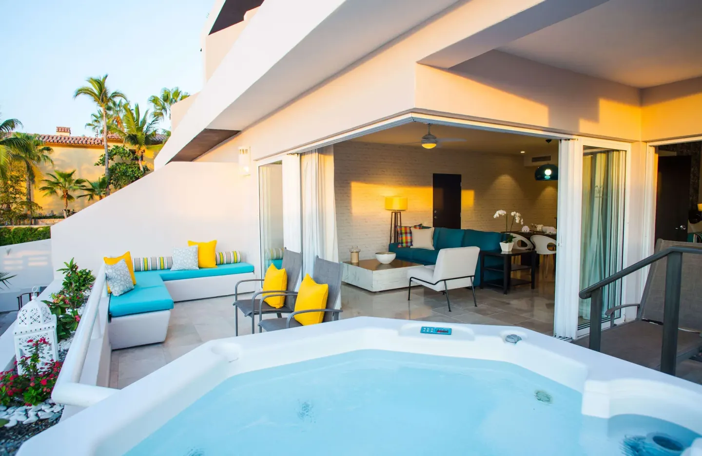 Private terrace with hot tub, lounge seating, and open suite doors at Corazón Cabo.