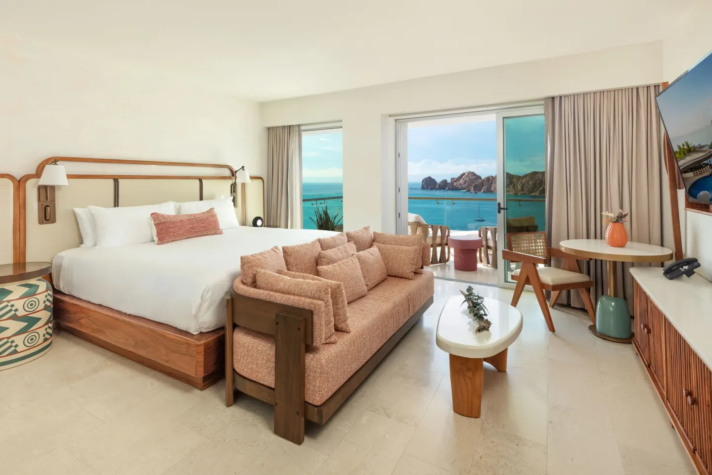 Infinity Ocean View king bed and sitting area with balcony at Corazón Cabo.