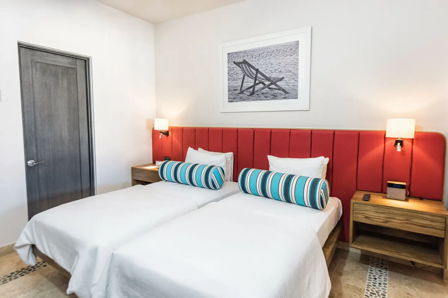 Twin beds with red headboard in a Luxury Suite, 2 Bedrooms at Corazón Cabo.