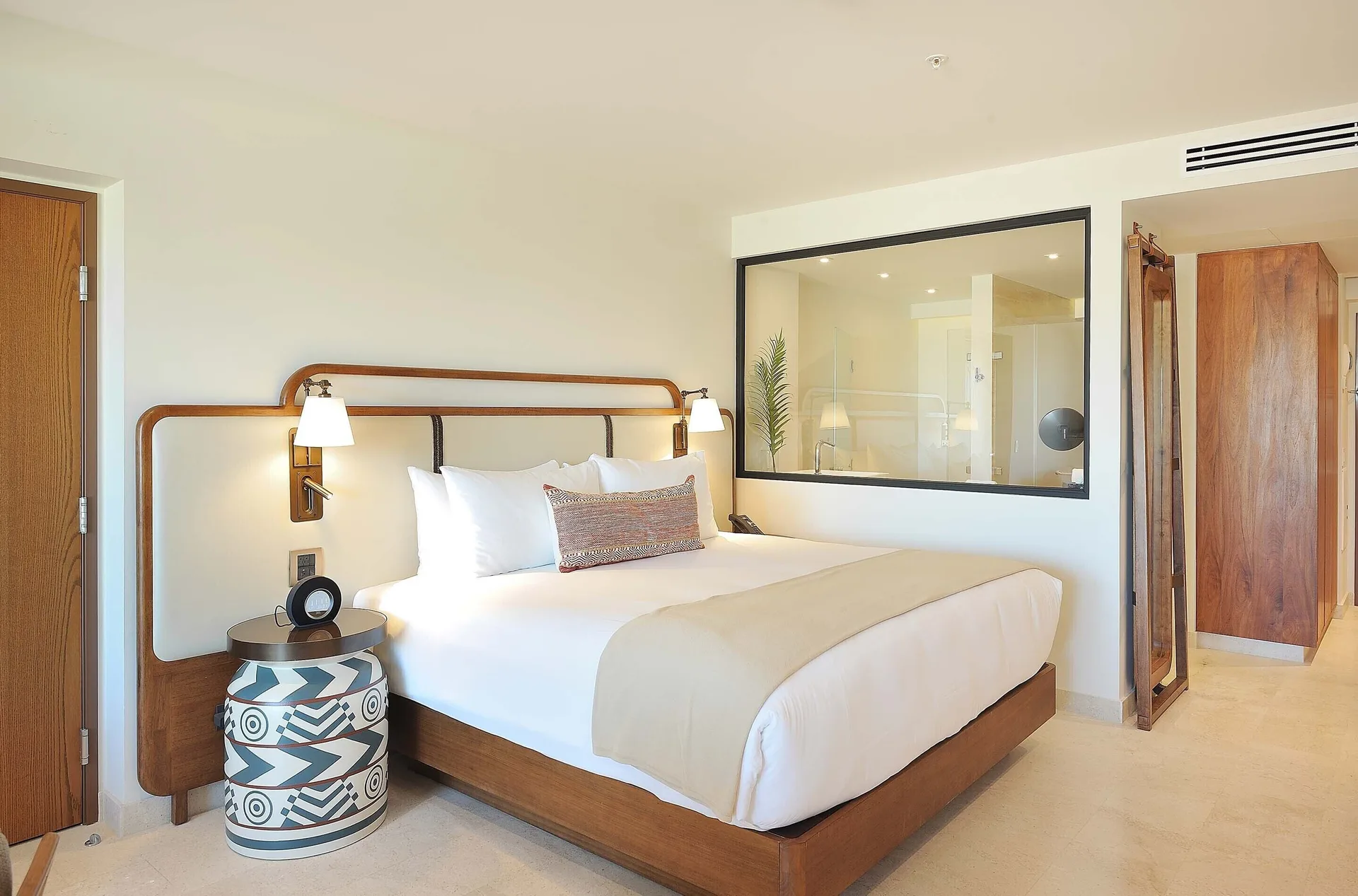 Infinity Sunset View room with king bed and glass bathroom wall at Corazón Cabo.