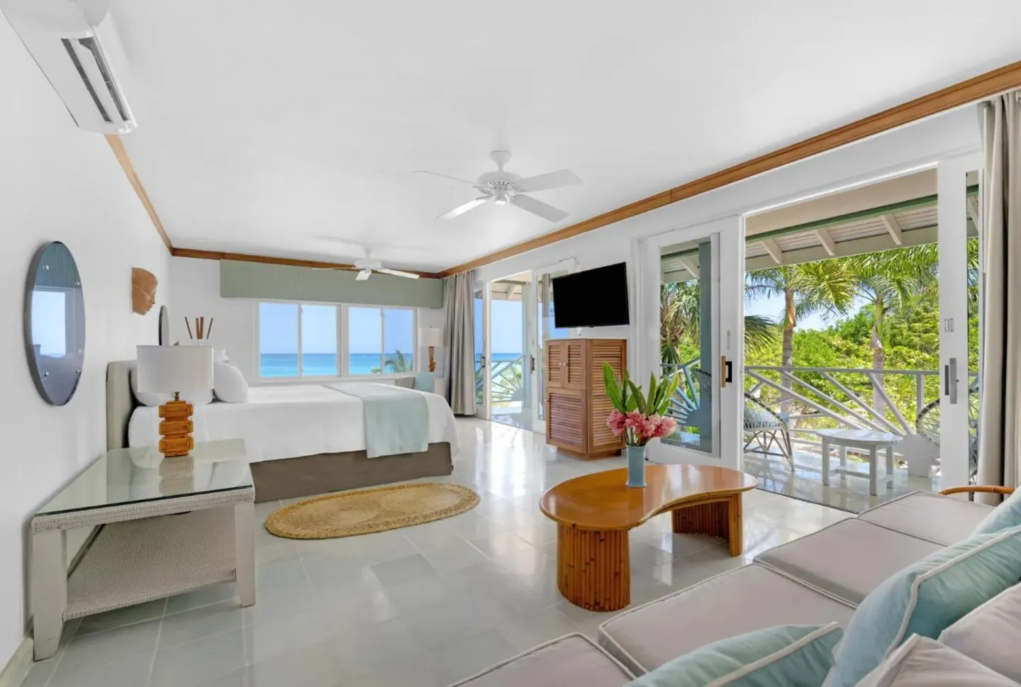 Spacious ocean-view guest room with king bed and seating at Couples Negril.