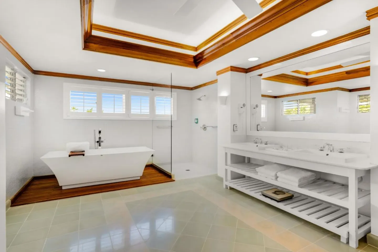 Spa-style bathroom with freestanding tub and double vanity at Couples Negril.