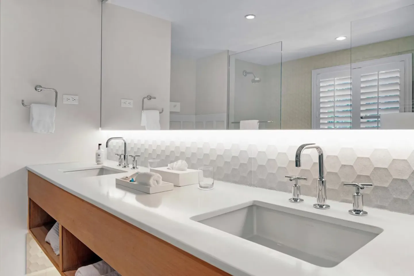 Modern double-sink bathroom vanity with large mirror at Couples Sans Souci.