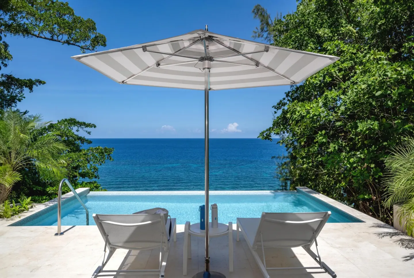Private plunge pool with loungers and ocean view at Couples Sans Souci.