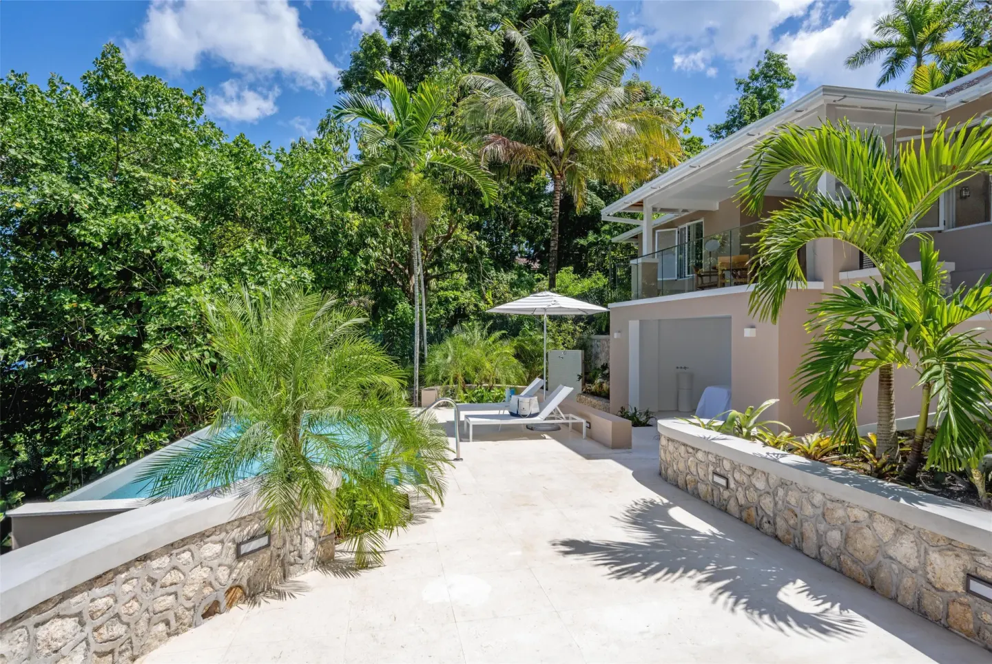 Tropical pool terrace beside a resort building at Couples Sans Souci.
