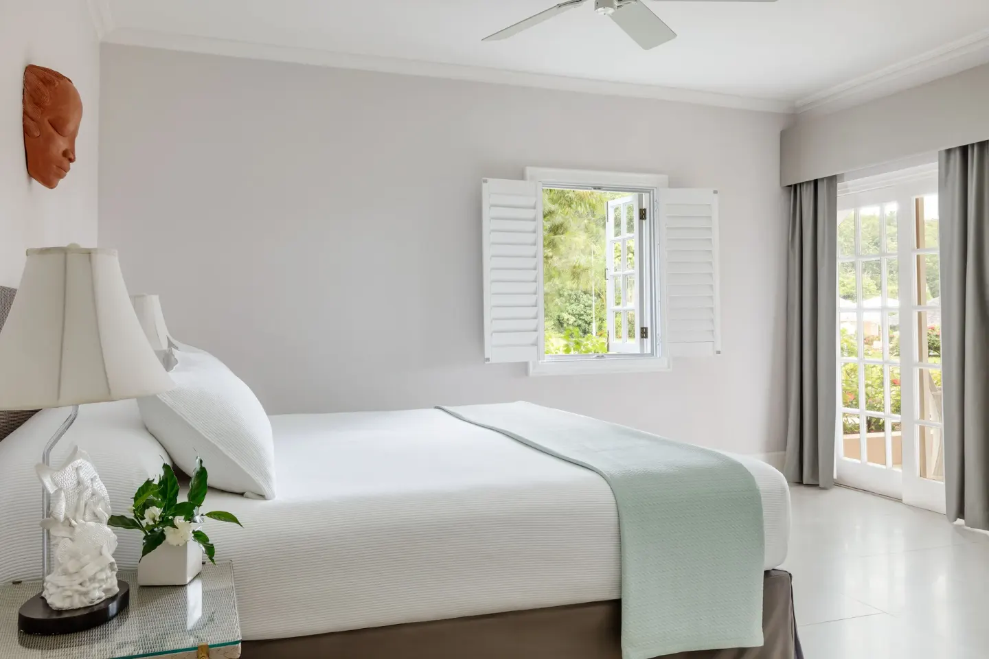Beach Front Suite king bed and bright windows at Couples Sans Souci.