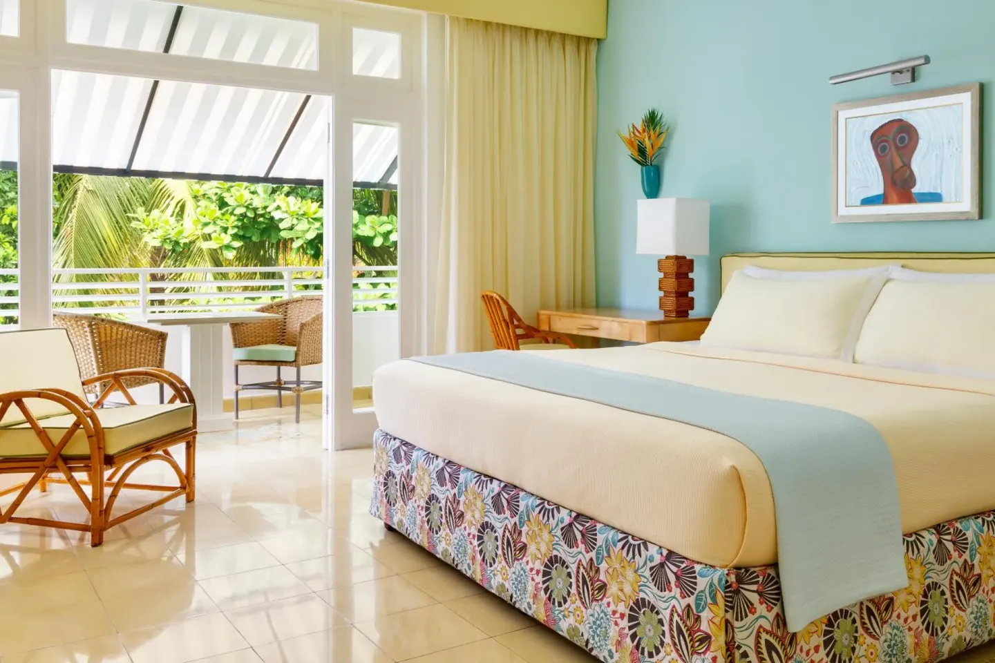 Guest room with a king bed, sitting area, and balcony at Couples Tower Isle.