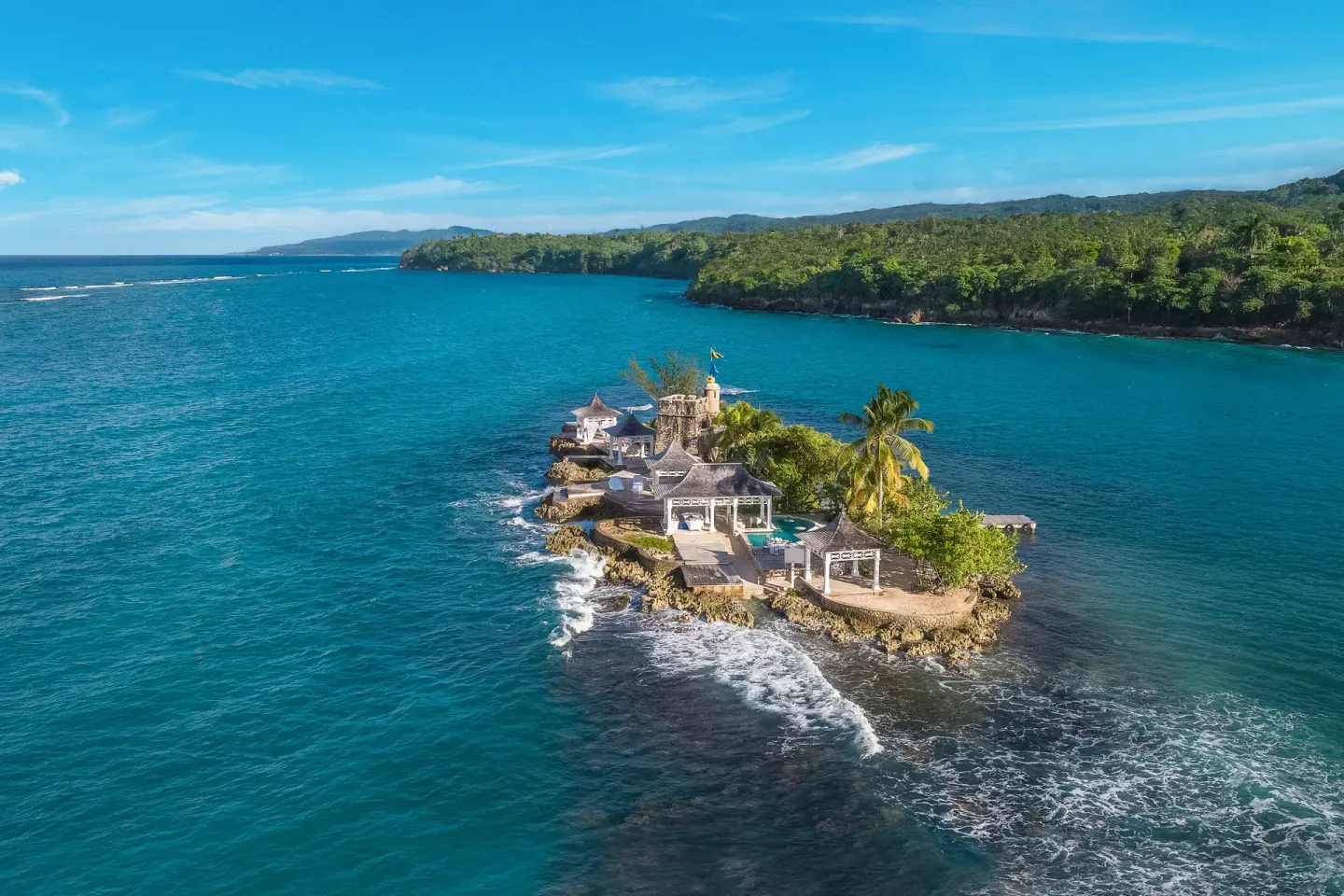 Aerial view of the offshore island in deep blue water at Couples Tower Isle.