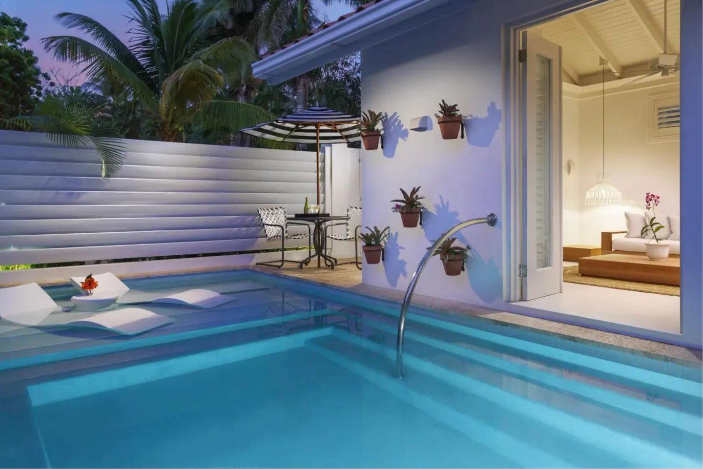 Private plunge pool beside a bright suite patio at Couples Tower Isle.