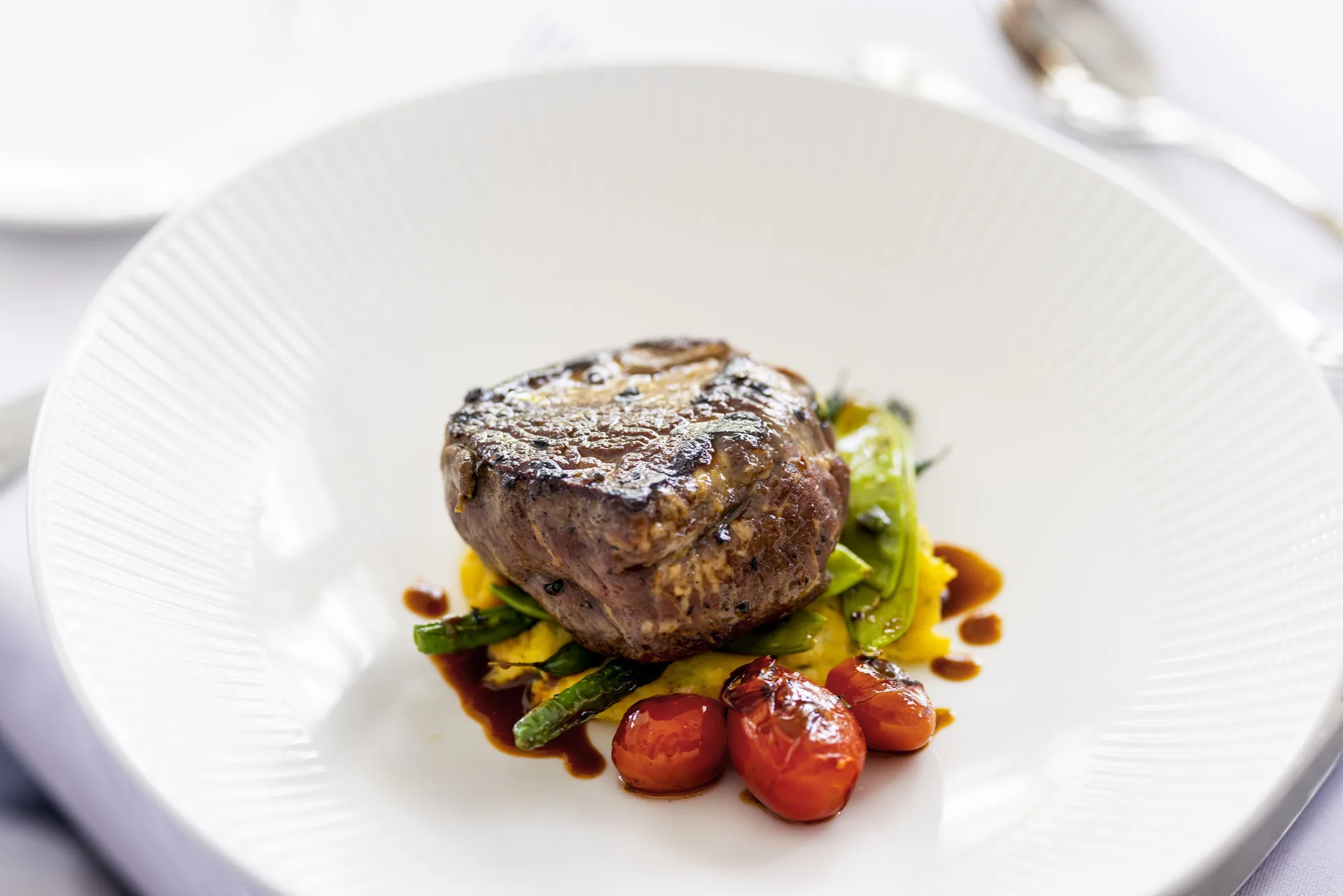 Plated grilled steak with vegetables served at Couples Tower Isle.
