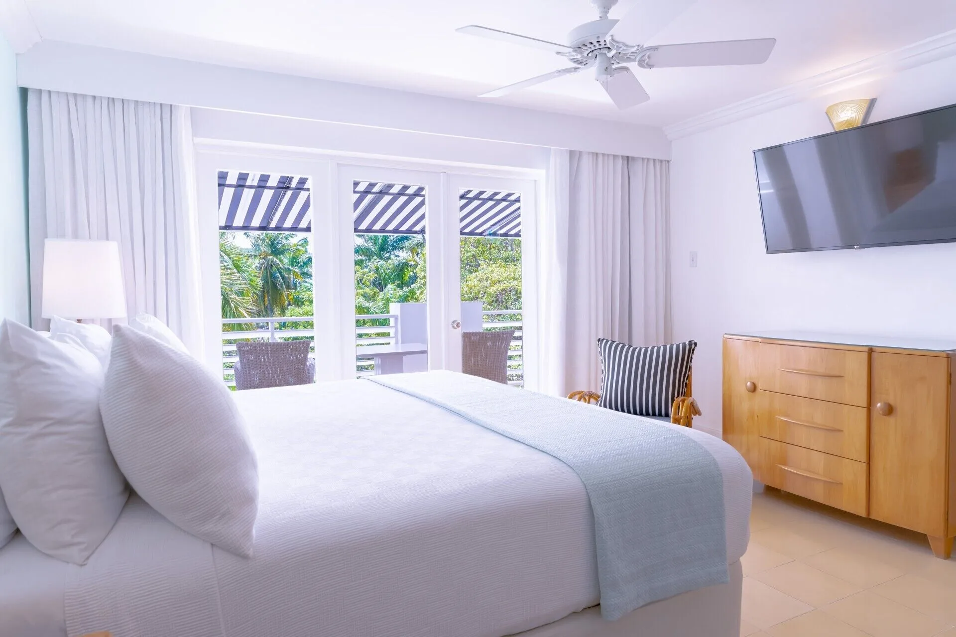 Garden Junior Suite bedroom with king bed and balcony greenery at Couples Tower Isle.