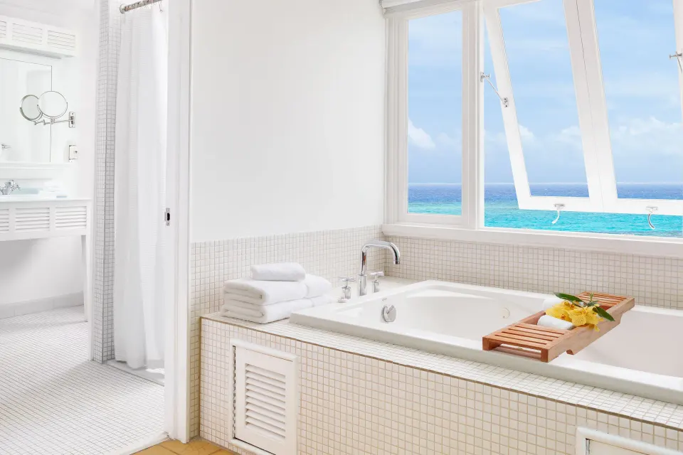 One Bedroom Ocean Suite bathroom tub with ocean view at Couples Tower Isle.