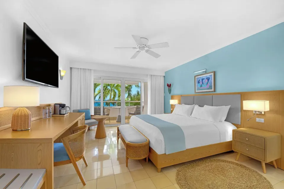 Premier Ocean guest room with king bed and balcony at Couples Tower Isle.