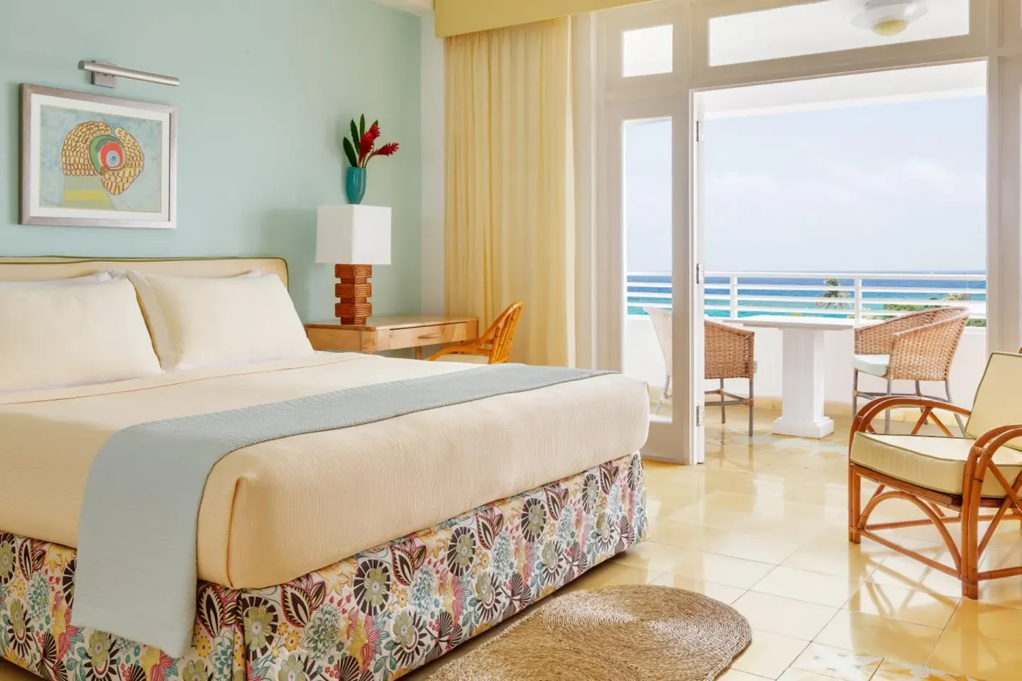 Premier Ocean guest room with king bed and ocean-facing balcony at Couples Tower Isle.