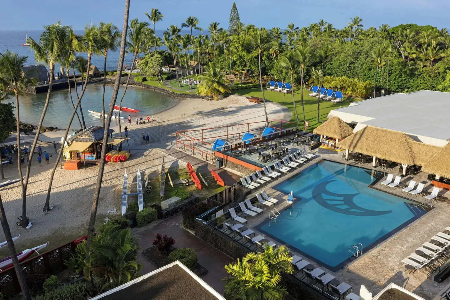 Aerial view of pool, beach and palms at Courtyard King Kamehameha's Kona Beach Hotel.