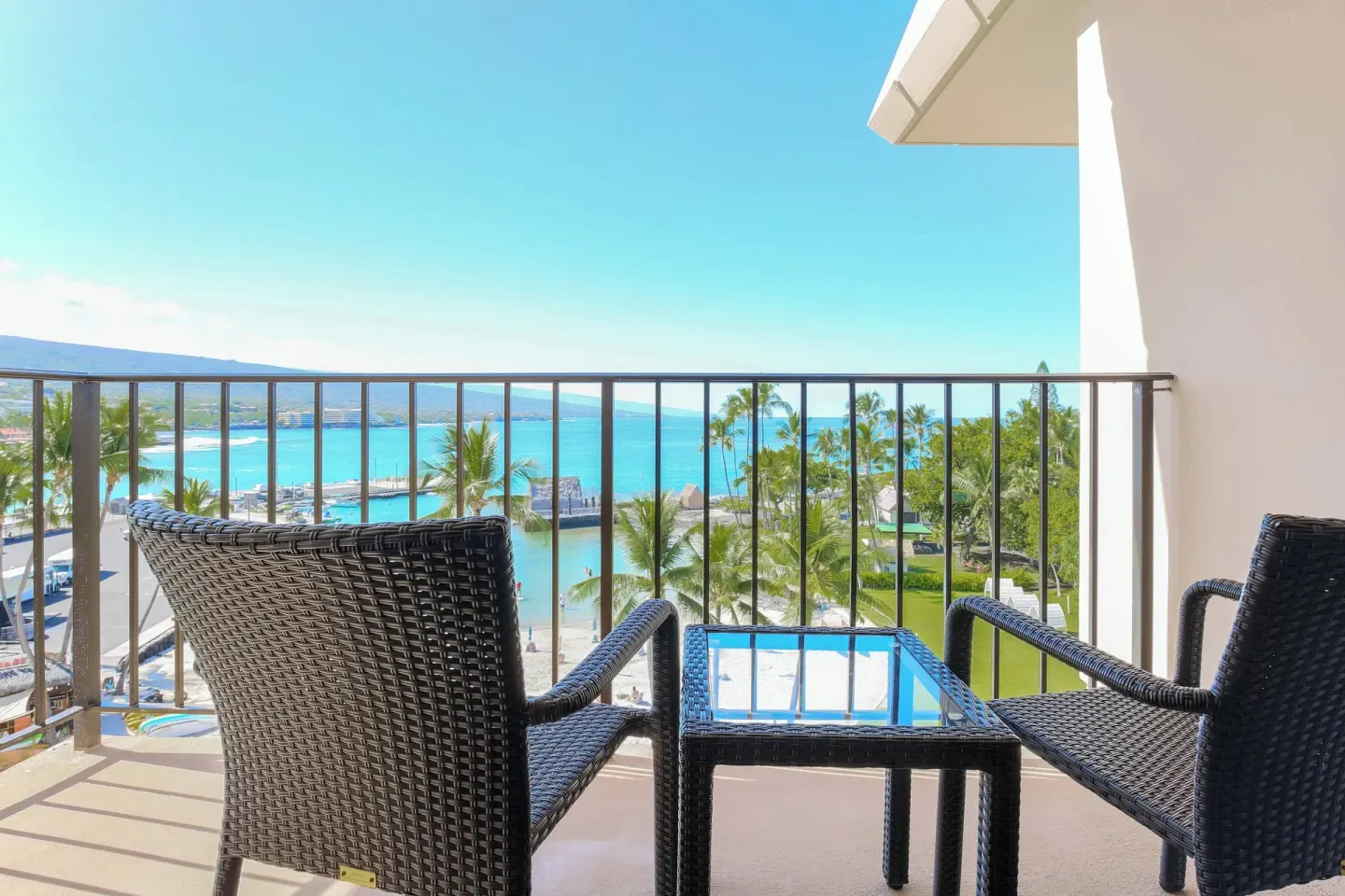 Balcony chairs facing ocean view at Courtyard King Kamehameha's Kona Beach Hotel.