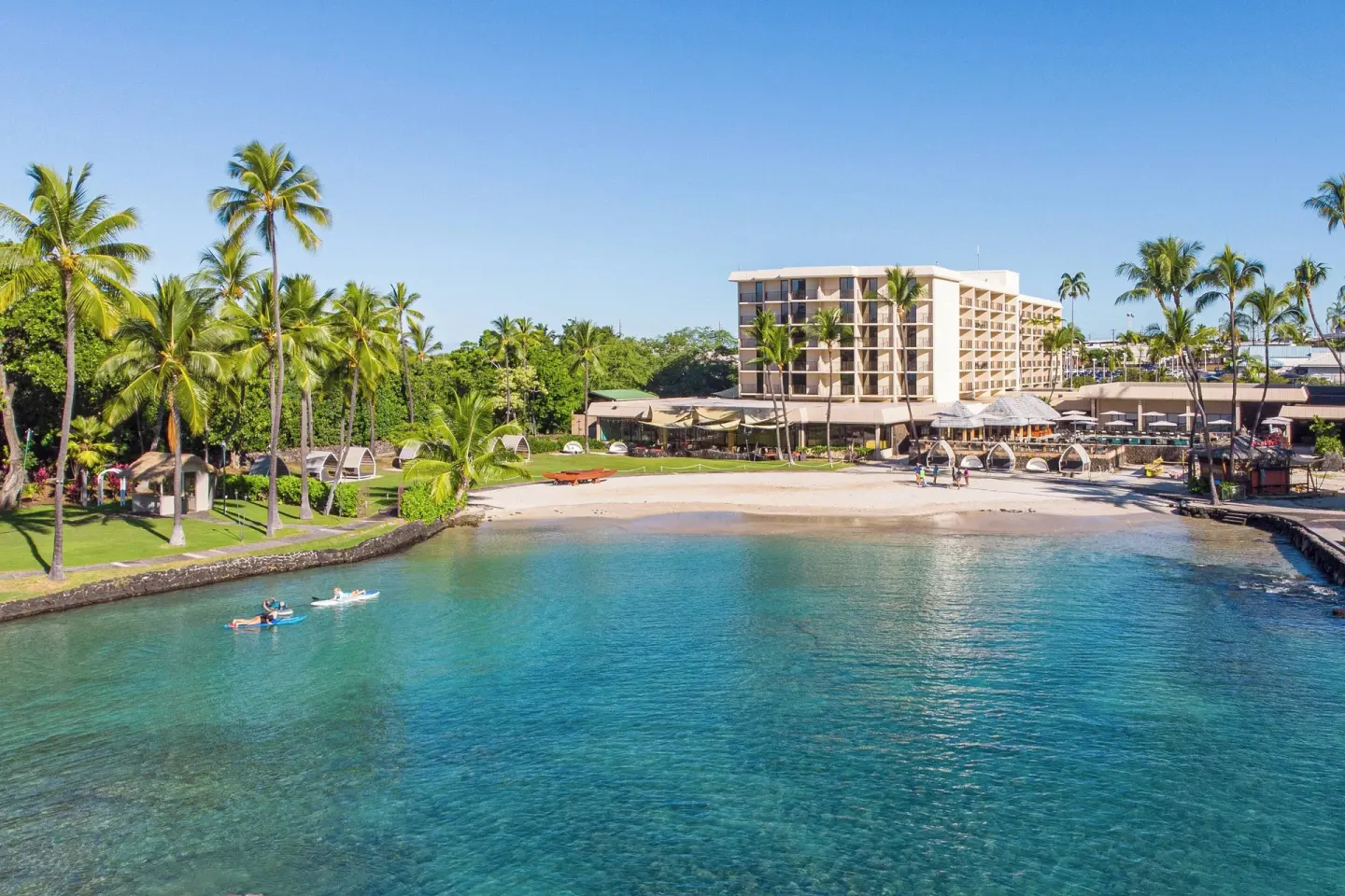 Beachfront bay and hotel building at Courtyard King Kamehameha's Kona Beach Hotel.